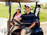 man and woman in golf cart